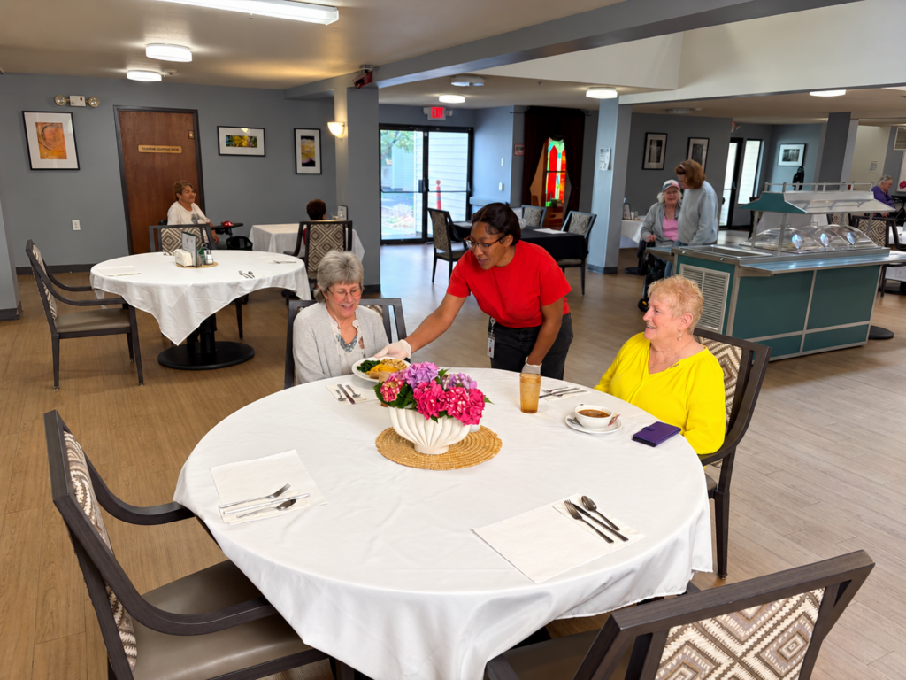 Residents enjoying a meal with a team member at The Creston in Portland, Oregon