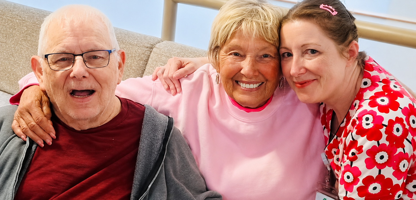 Two residents smiling with a team member at The Creston in Portland, Oregon